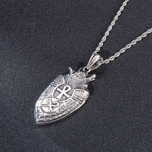 Macro shot of silver stainless steel wolf shield pendant with Egyptian Ankh symbols