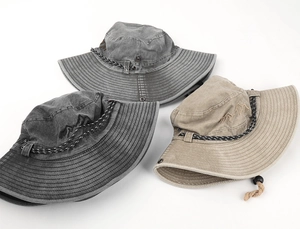 Detail of washed cotton fisherman hats featuring mountain embroidery and adjustable cords