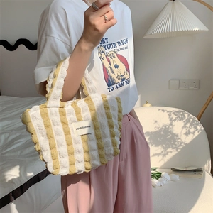Close-up of yellow striped bubble fabric handbag with Love Sozakka label detail