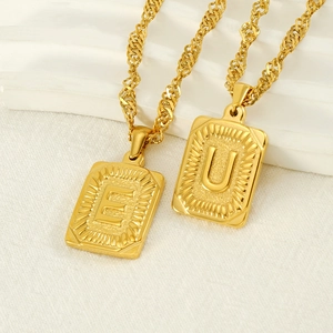 Gold stainless steel necklace with square letter pendants E and U on twisted chains