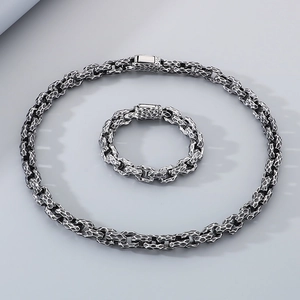 Close-up of vintage hammered texture stainless steel necklace and bracelet set in silver