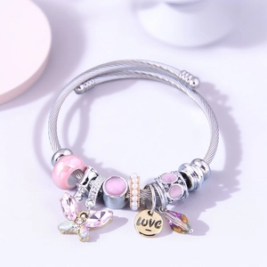 Detail of stainless steel charm bracelet with pink crystals and butterfly love charms