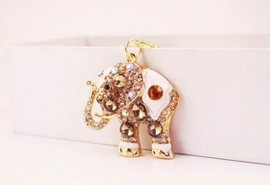 Detailed view of golden elephant keychain with white enamel and sparkling rhinestones