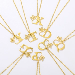 Artistic gold stainless steel initial necklaces with female silhouette and leaf details