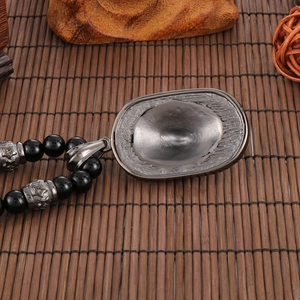 Macro detail of lion head pendant back with black beads and star pattern spacer beads