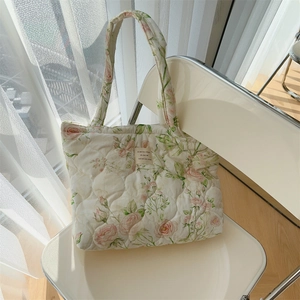 Detail view of floral quilted cotton tote bag with vintage rose pattern and fabric label