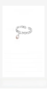 Macro detail of S925 sterling silver hollow heart ring with hanging pearl tassel and charm