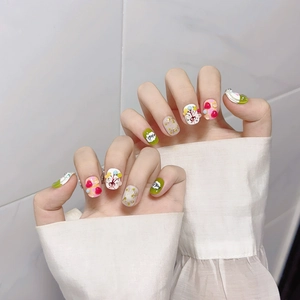 Cute short round hand-painted press-on nails with floral and heart spring patterns