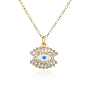Detail of 18K gold plated evil eye pendant with blue enamel and zircon stones