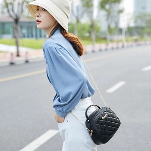 Classic black quilted handbag with gold chain strap and top handle for women fashion