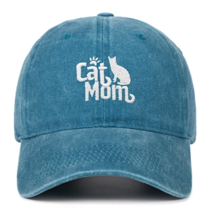 Detailed white embroidery of Cat Mom text and cat silhouette on washed navy baseball cap