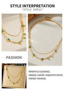 Close-up of double-layer gold plated necklace with green beads and round pendants