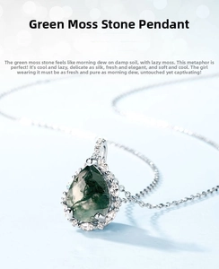 Macro view of teardrop green moss agate pendant with sparkling zircon halo on silver chain