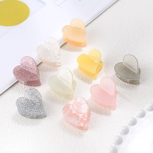 Colorful acetate heart hair claws in glitter and marble finishes for women