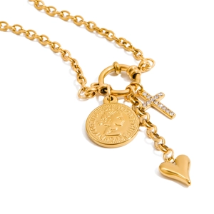 Close-up of gold titanium steel coin, cross and heart charms on a pearl necklace