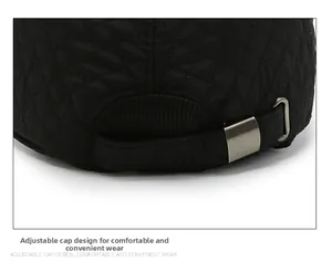 Detail of black quilted baseball cap featuring diamond stitching and adjustable strap