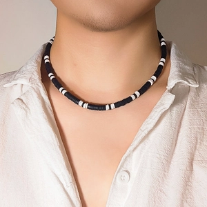 Minimalist black and white clay disc bead necklace for men worn with a white shirt
