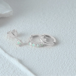 Detailed macro of S925 sterling silver evil eye earrings set with opal stones