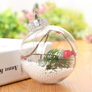 Detail of 8cm clear Christmas ball ornament with pine needles, berries and faux snow