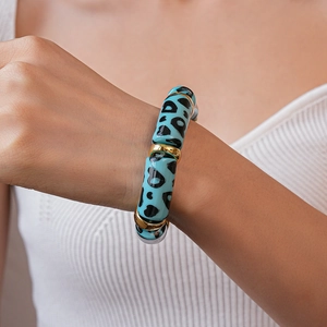Close-up of sky blue acrylic bead bracelet with leopard print and gold spacers