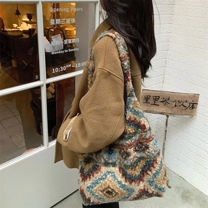 Close-up of a large bohemian knit tote bag featuring a retro geometric diamond pattern