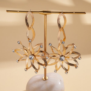 Luxurious gold starburst earrings with sparkling crystals and metal chain drops