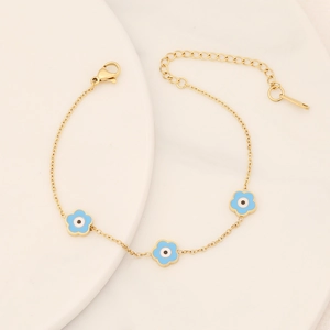 Detail of gold flower bracelet with blue evil eye petals and adjustable lobster clasp