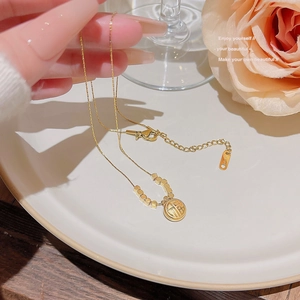 Detail of 18K gold-plated titanium necklace with lobster clasp and Fu character pendant