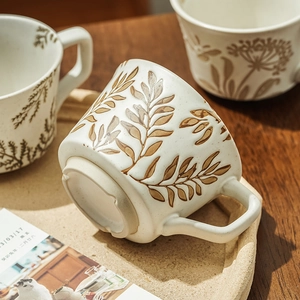Hand-painted ceramic coffee mug with brown leaf pattern on oatmeal glaze and square handle