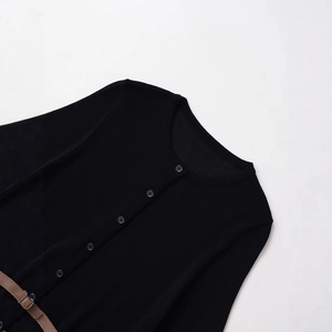 Women's black knit cardigan with round neck and brown waist belt on white background