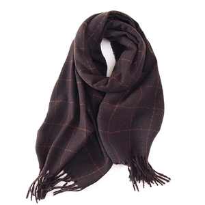 Thick winter scarf with deep brown and orange plaid pattern and classic tassel details