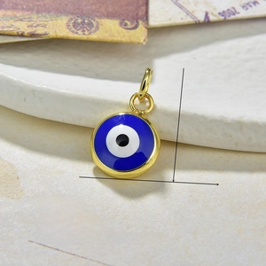Macro shot showing 17mm gold Evil Eye pendant size and 0.7g weight specifications