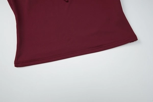 Detail shot of wine red knitted hemline showing professional double-needle stitching quality