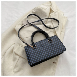 Detail of lychee pattern bag with blue geometric circles and gold square hardware