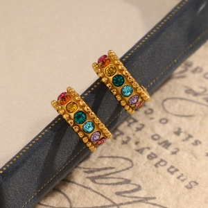 Close-up of 18K gold plated C-shaped earrings with colorful rainbow cubic zirconia