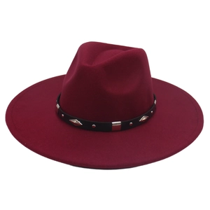 Close-up of wine red fedora hat with black faux leather belt and silver metal studs