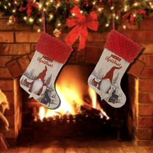 Red and beige Christmas stockings with gnome and reindeer patterns hanging by a cozy fireplace