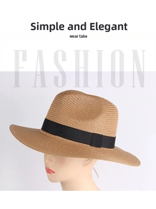 Close-up of natural straw weave and black satin ribbon detail on a summer Panama hat