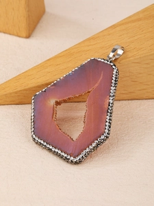 Detailed macro view of an irregular geode pendant with sparkling crystals and pavé rhinestones