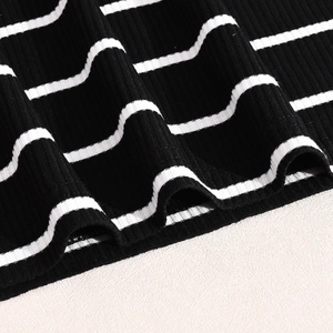 Close-up of black and white striped rib-knit fabric texture and hemline detail