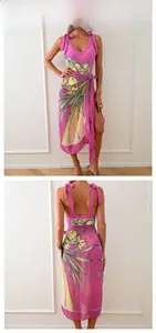 Detail view of pink floral chiffon beach dress with bow straps and wrap hem design
