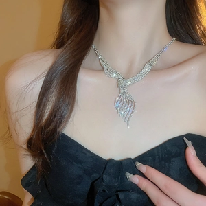 Macro shot of silver leaf necklace set with rhinestones on model neck for gala wear