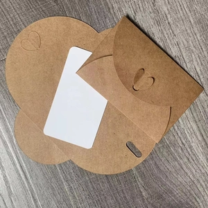 Detail view of vintage kraft paper envelope set with heart shaped closure and card