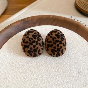 Close-up of velvet flocked oval leopard print earrings with warm brown texture