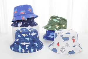 Detail of baby sun hats featuring marine patterns like sharks and anchors in soft cotton