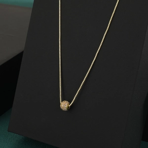 Elegant gold chain necklace featuring a sphere pendant pavé-set with pink zircon stones