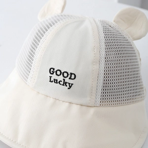 Cream-colored baby sun hat with Good Lucky embroidery and mesh panels for summer protection