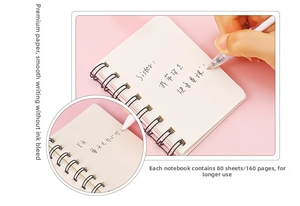 Detail of A7 mini spiral notebook featuring lined inner pages and black metal wire-o binding