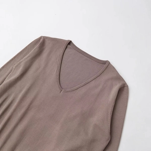 Minimalist V-neck knit top in taupe featuring ribbed neckline and soft fabric texture