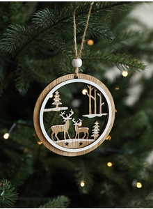 Detail of wooden Christmas tree ornament with reindeer cutout and warm glowing lights